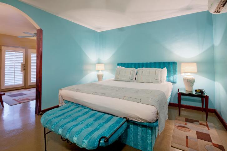 turquoise-bedroom-with-light-wood-flooring