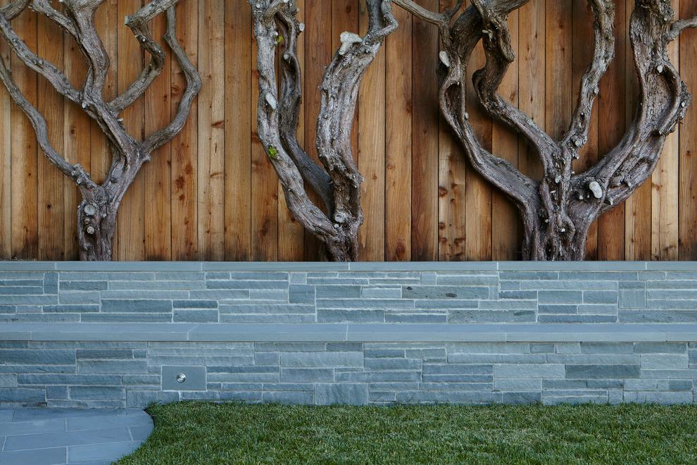 Combined fence of decorative stone and wooden fences