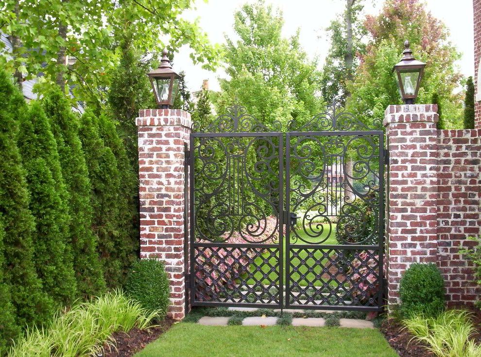 Forged gates perfectly combined with brick wall