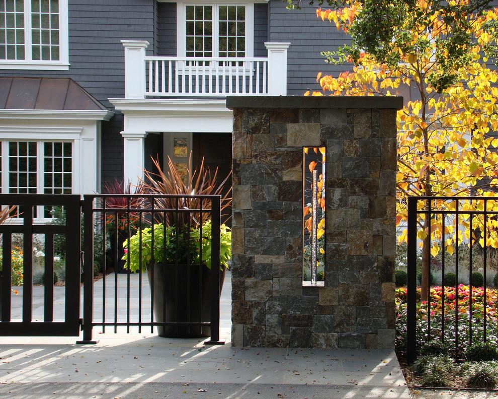 Modern metal fence with stone pillars