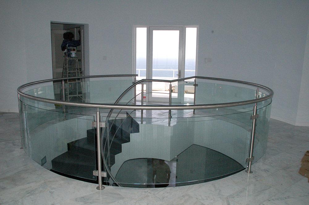 Custom curved glass railing with stainless steel