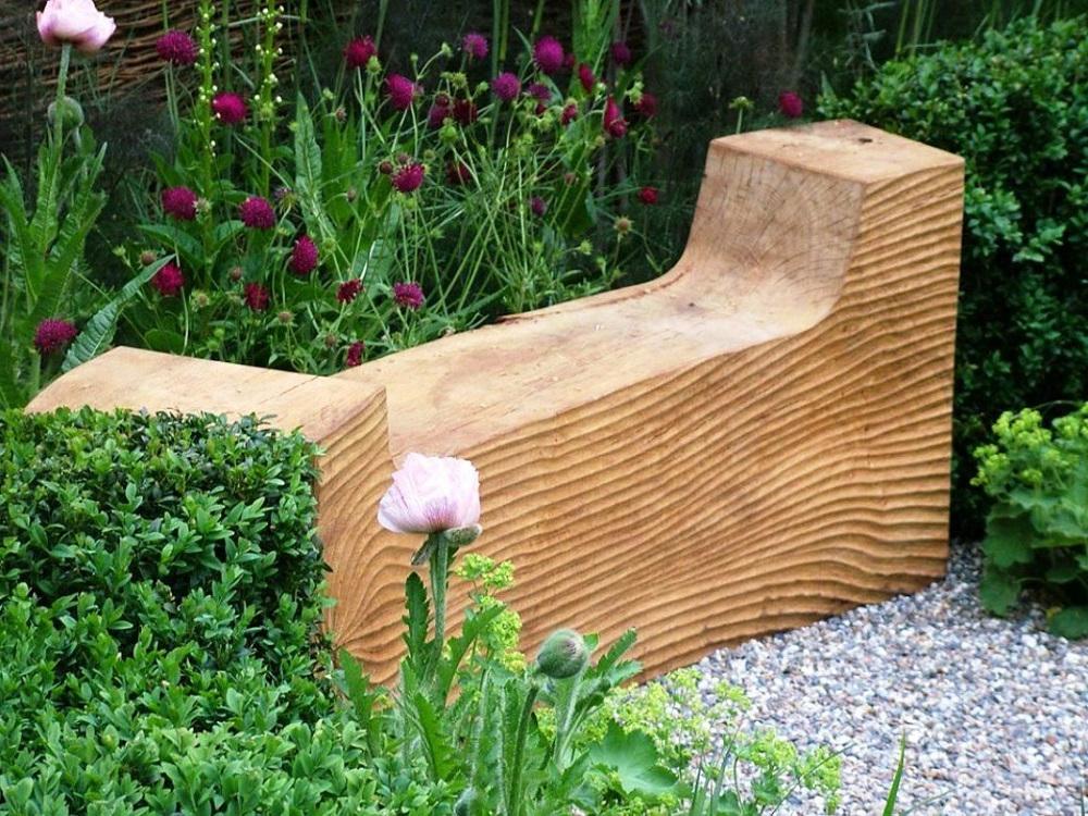 Wooden bench from a solid beam with armrests