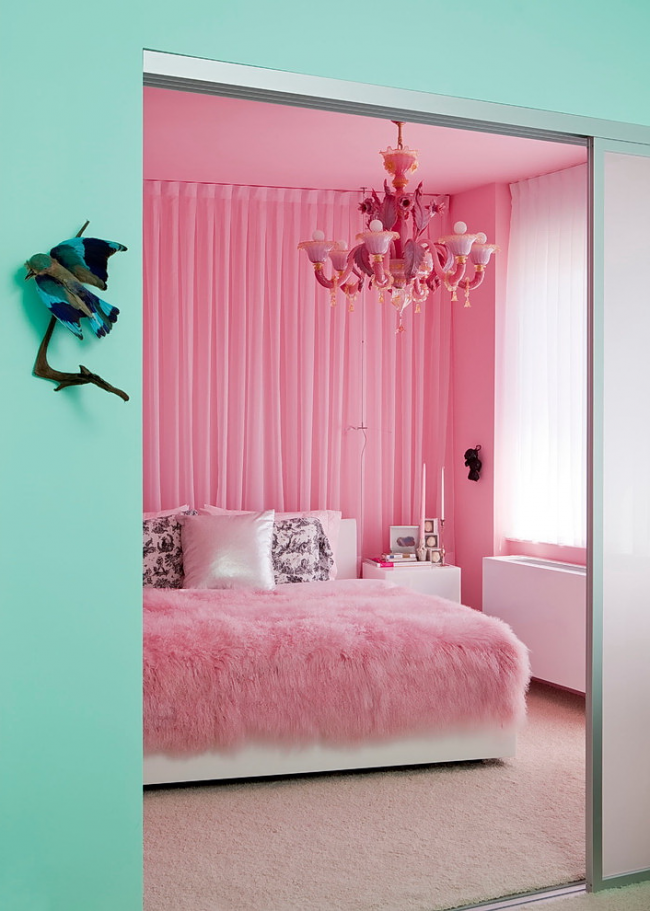 Bright pink chandelier underlines the overall style