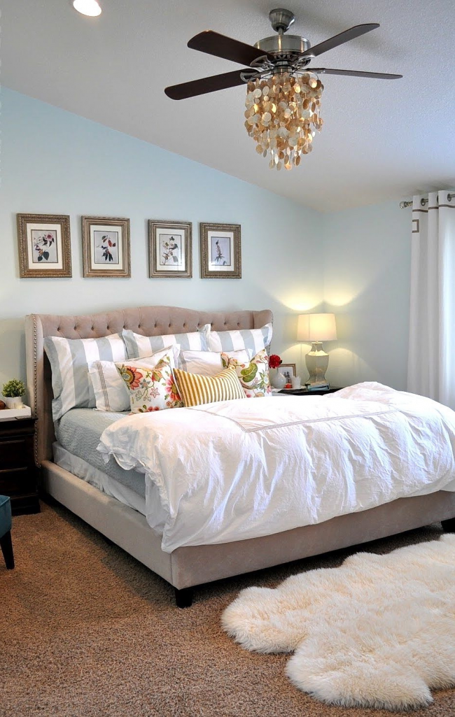 Chandelier with a fan in the bright bedroom