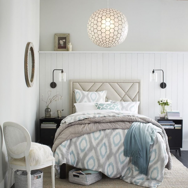 Modern chandelier in the bright bedroom