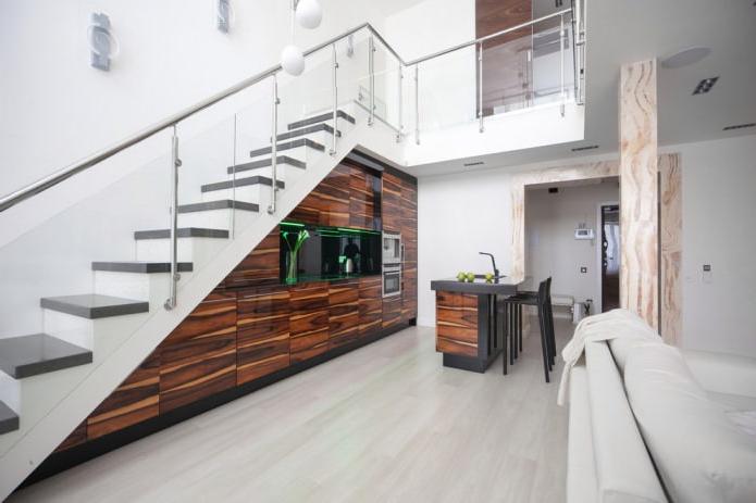 modern kitchen built into the flight of stairs