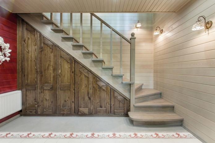 wooden cabinet under the stairs with hinged doors