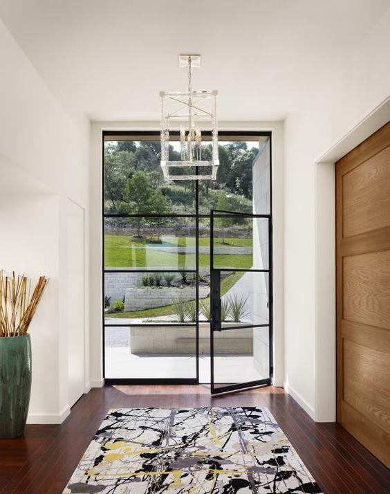 oversized blackened steel frame glass front door