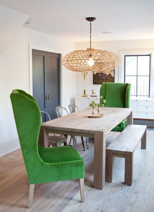 Contrasting green chairs and an unusual chandelier