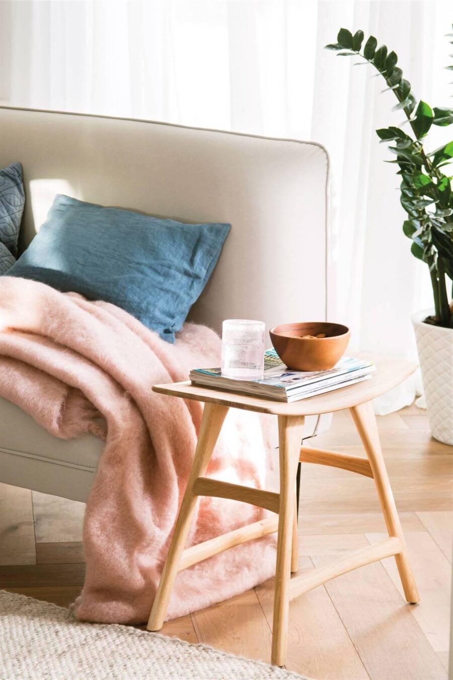 A LOW WOODEN STOOL WITH AN ORIENTAL TOUCH