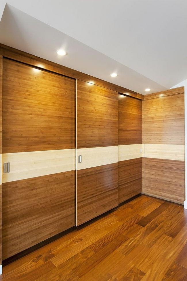 Corner walk-in closet with wooden door