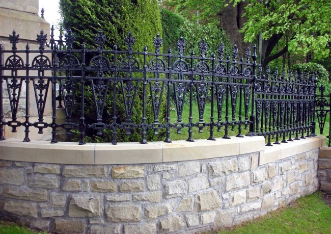 Fence with stone base and forged top