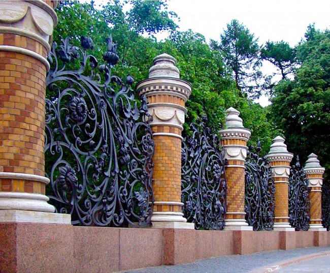 Luxurious, majestic forged fence with monumental brick supports