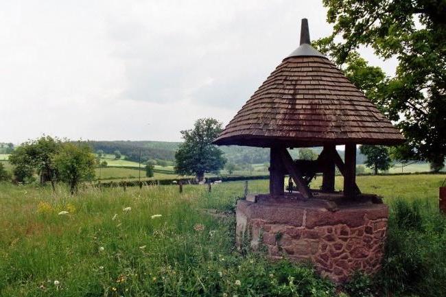 Beautiful cone-shaped house for a well