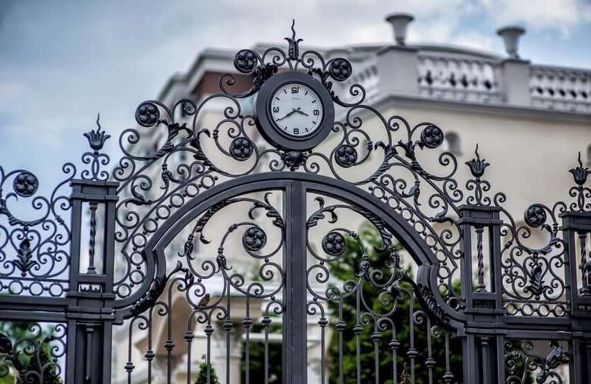 Forged fence with a clock - an interesting idea