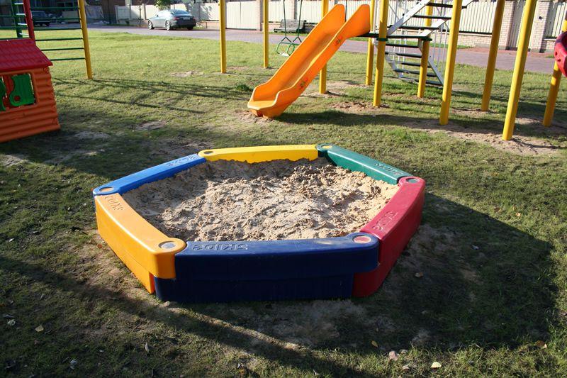 Linear polyethylene sandbox on the play lawn