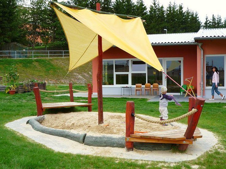 DIY Sandbox with sides, logs and awning, simulating a sail