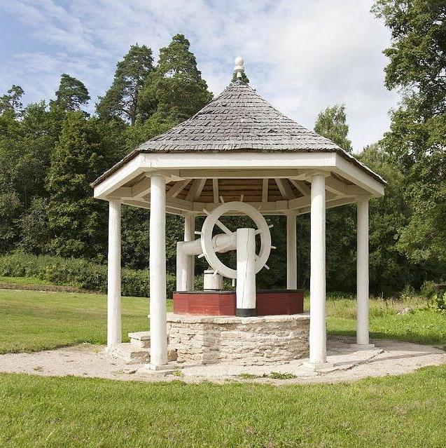 Spectacular house for a well with a roof in the form of a hexagonal pyramid