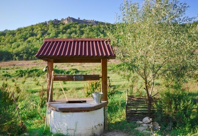 Well house with a base of concrete rings