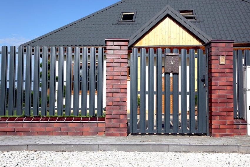 Fence made of metal picket fence with brick posts