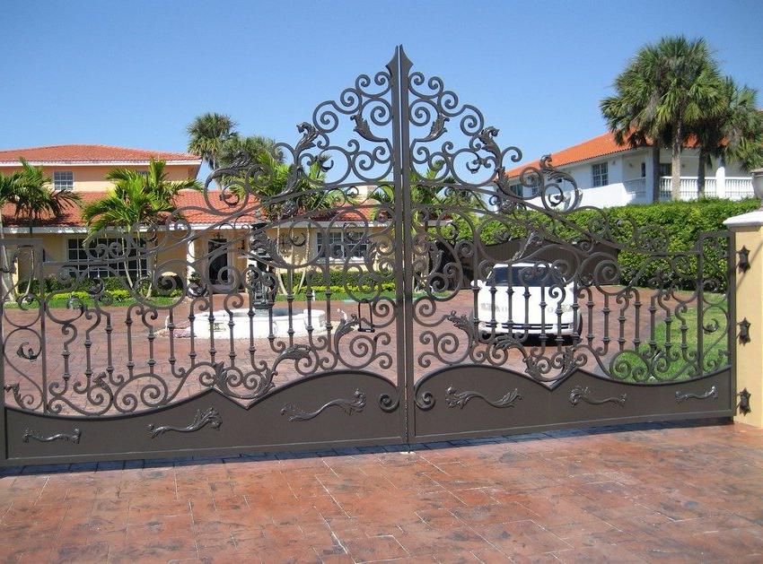 Metal swing gates with an abundance of openwork forged elements