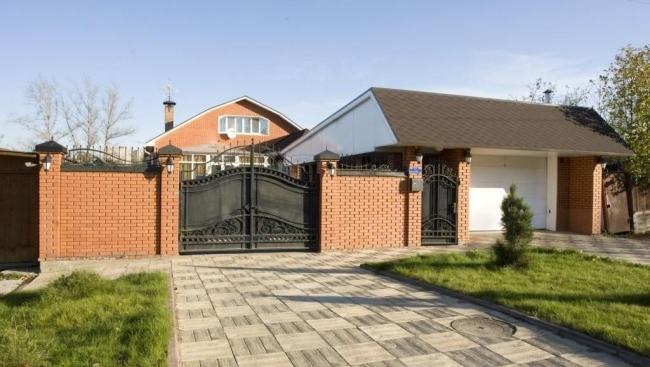 Wrought iron swing gate with a wicket