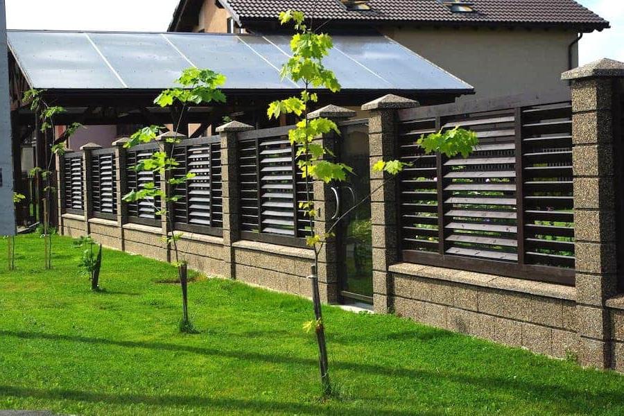 Beautiful combined fence made of wood and stone